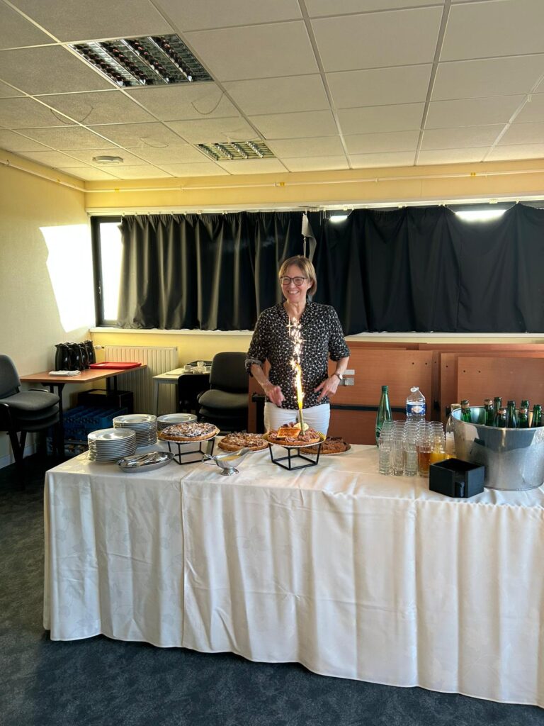 Sur cette photo, Françoise Maugé, Directrice de Recherche CNRS au laboratoire Catalyse et Spectrochimie, se tient souriante derrière une table joliment dressée avec des desserts et des boissons. L’événement, organisé en son honneur, célèbre son départ à la retraite, bien qu’elle continue de contribuer en tant que chercheuse émérite.